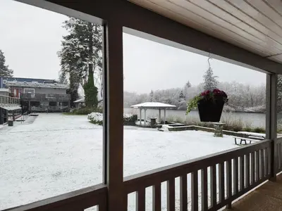 a view of a snow covered yard from a porch at Campbell River Lodge in Campbell River