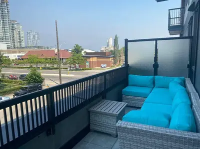 a balcony with blue pillows and a couch at Spacious 2-bed, 2-bath condo in downtown Kelowna! in Kelowna