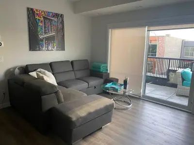 a living room with a couch and a table at Spacious 2-bed, 2-bath condo in downtown Kelowna! in Kelowna