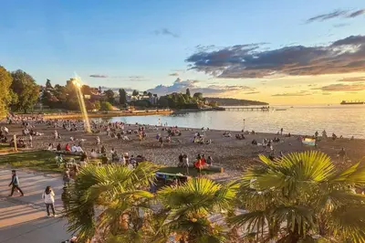 a crowd of people on the beach at sunset at Small Private Studio at Kitsilano Beach in Vancouver