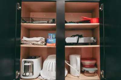 a cupboard filled with lots of kitchen appliances at Small Private Studio at Kitsilano Beach in Vancouver
