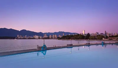 a large swimming pool next to a large body of water at Small Private Studio at Kitsilano Beach in Vancouver