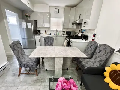 a kitchen with a table and two chairs and a table at Vancouver’s Homey Laneway House in Vancouver