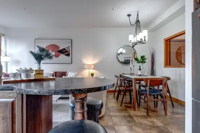 a kitchen and dining room with a table and chairs at Central 2BR with Prime Amenities in Whistler