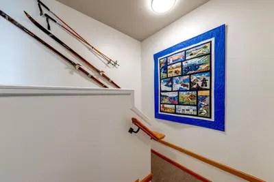 a staircase with a painting on the wall at Central 2BR with Prime Amenities in Whistler