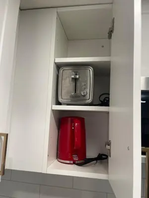 a white cupboard with a toaster and a toaster at Stylish 2 Bedroom suite in SW Edmonton close to Windermere and Edmonton International Airport in Edmonton