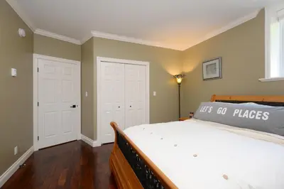 a bedroom with a large bed and a window at Upscale Character Home with Luxurious Amenities in Victoria