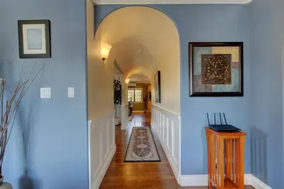 a hallway with blue walls and an archway at Character Stay across Swan Lake Nature Sanctuary in Victoria