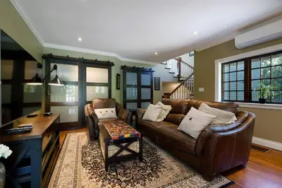 a living room with a couch and a table at Character Stay across Swan Lake Nature Sanctuary in Victoria