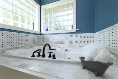 a bath tub in a bathroom with a window at Character Stay across Swan Lake Nature Sanctuary in Victoria