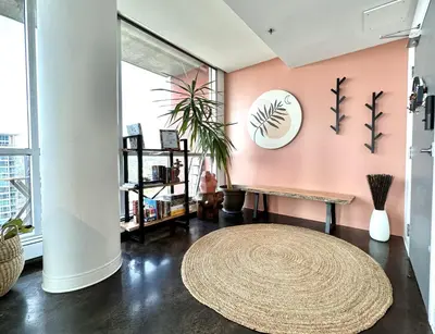 a living room with a bench and a rug at ColoursNest - Downtown apt spectacular view and location in Calgary
