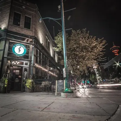 a building with a clock on the side of a street at ColoursNest - Downtown apt spectacular view and location in Calgary