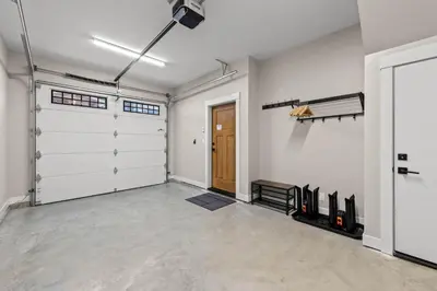 a garage with white walls and a door at Powder Heights #18 townhouse in Sun Peaks