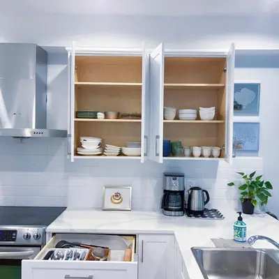 a kitchen with white cabinets and a sink at Ground level two bedrooms Suite near Lake and Golf Course in Victoria