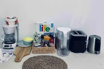 a kitchen counter with a coffee maker and a blender at Richmond Cozy Place 2 in Richmond