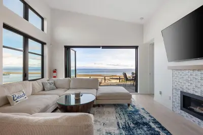 a living room with a couch and a fireplace at Beachfront Villa #14 at The Beach House in Campbell River