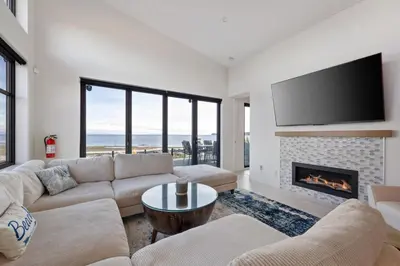 a living room with a couch and a fireplace at Beachfront Villa #14 at The Beach House in Campbell River