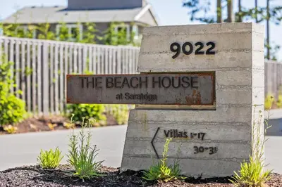 a sign that says the beach house at sanctuary at Beachfront Villa #14 at The Beach House in Campbell River