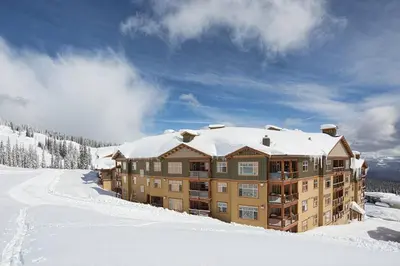 a large building with snow on top of it at Luxury Aspens 2 Bdrm Condo with Best Views in Big White