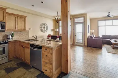 a kitchen with a counter and a living room at Luxury Aspens 2 Bdrm Condo with Best Views in Big White