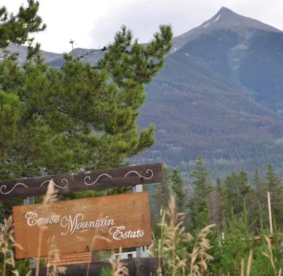 a sign with a mountain in the background at Right Choice Home Valemount in Valemount