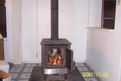 a wood burning stove in a room at Right Choice Home Valemount in Valemount