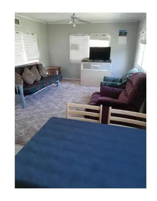 a living room with a blue table and a couch at Right Choice Home Valemount in Valemount