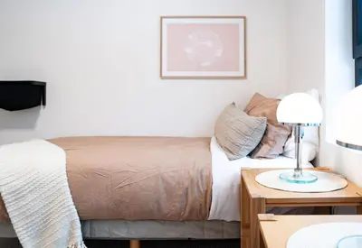 a bedroom with a bed and a table with a lamp at Snow & Swing Getaway - Three Bedrooms with Hot Tub (Stay Revy) in Revelstoke
