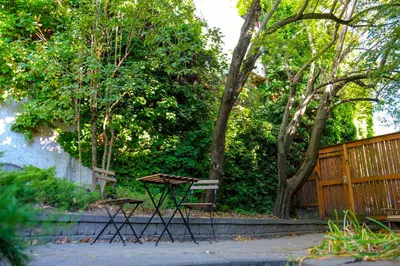 a picnic table and a bench in a garden at Dancing Bear Inn in Nelson