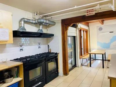 a kitchen with a black stove top oven at Dancing Bear Inn in Nelson