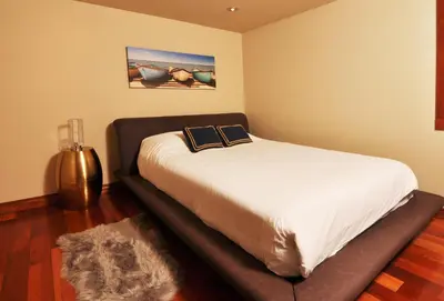 a bedroom with a bed with two books on it at Exclusive Private Island - Pacific Ocean Paradise in Madeira Park
