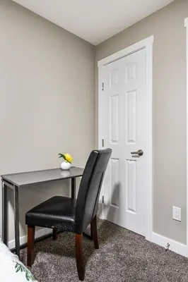 a bedroom with a desk and a chair at Newly renovated 2 bedroom basement suite in Calgary