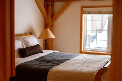 a bedroom with a large bed and a window at Alpine Timber Luxury Chalet w/Hot Tub in Big White