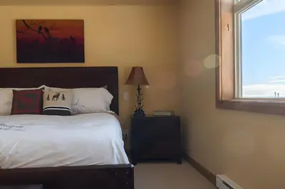 a bedroom with a bed and a window at The Aspens 5 w/ Hot Tub in Big White