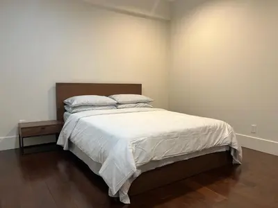 a bedroom with a large bed with white sheets and pillows at Cozy and Private Suite in Richmond in Richmond