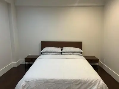 a bedroom with a large bed with two pillows at Cozy and Private Suite in Richmond in Richmond