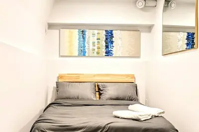 a small bedroom with a bed with two pillows at 2 Bed Apartment Free Parking Central Location in Vancouver
