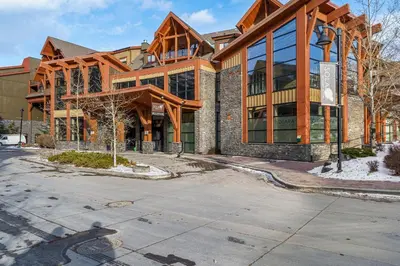a large wooden building with a lot of windows at Adventurer's Escape~ Mountain Luxury Resort in Canmore