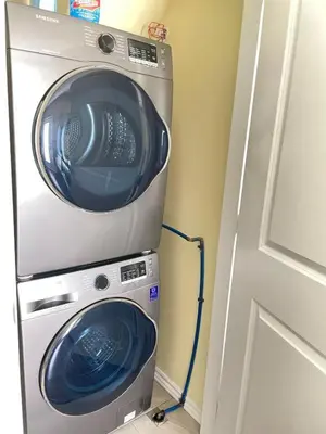 a washer and dryer in a room next to a door at Arbutus summer house in Vancouver
