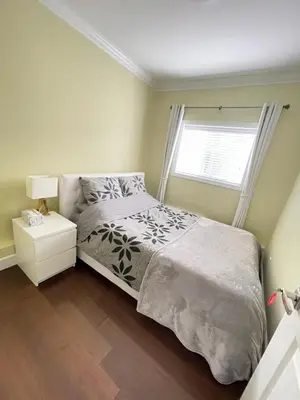 a bedroom with a bed and a window at Arbutus summer house in Vancouver