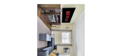 a hallway in a building with a sign on the ceiling at Arbutus summer house in Vancouver