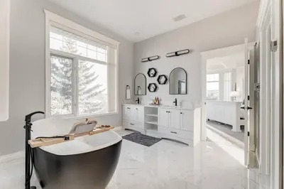 a bathroom with a tub and a sink at Emerald Bay Luxury Retreat with Hot Tub in Calgary