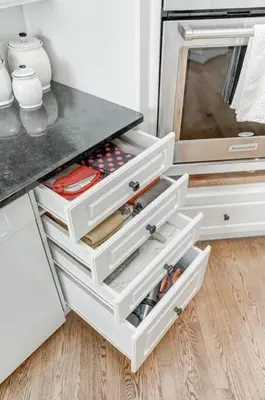 a kitchen with white drawers and a counter at Emerald Bay Luxury Retreat with Hot Tub in Calgary