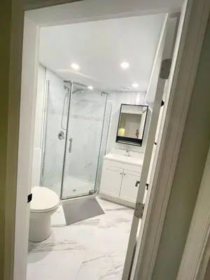 a bathroom with a shower and a toilet and a sink at Arbutus violet room in Vancouver