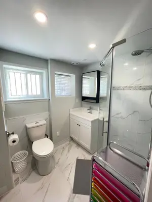 a bathroom with a toilet and a shower at Arbutus Jasmine room in Vancouver
