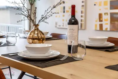 a bottle of wine sitting on a table with glasses at The Azure, Near DT & University, TWO King Beds! in Edmonton