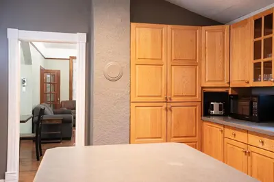 a kitchen with wooden cabinets and a counter top at Downtown Home Private Hot Tub Walkable Location in Revelstoke