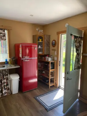 a kitchen with a red refrigerator in a room at 1868 Noble Cottage in Clearwater