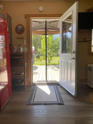 an open door with a view of a yard at 1868 Noble Cottage in Clearwater