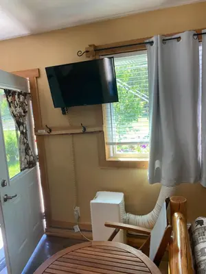 a room with a flat screen tv on the wall at 1868 Noble Cottage in Clearwater